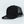 Load image into Gallery viewer, A black trucker-style baseball cap with a tonal black TODAE Icon A logo on the front panel and a black mesh back, shown on a clean white background with a hangtag attached.
