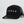 Load image into Gallery viewer, A black trucker-style cap with a curved brim, featuring the word 'TODAE' embroidered in white on the front panel and a black mesh back. A black hangtag is attached to the side.
